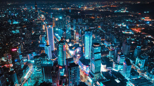 High angle view of illuminated buildings in city at night