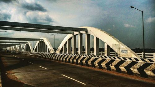 Low angle view of bridge against sky in city