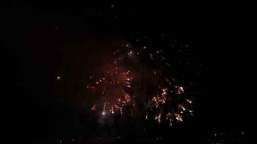 Low angle view of firework display at night