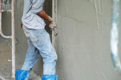 Low section of man working on wall