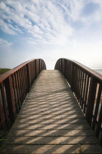 View of empty footbridge against sky