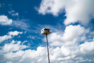 Low angle view of street light against cloudy sky