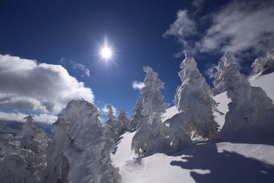 Low angle view of snow on mountain against sky