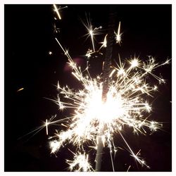 Low angle view of firework display at night