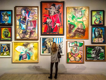 Full length of man standing against multi colored stage