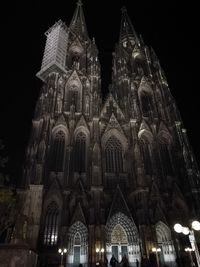 Low angle view of illuminated cathedral against sky at night