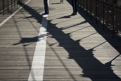 Shadow of woman on footpath