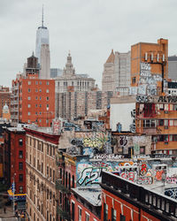 High angle view of graffiti on buildings in city against sky