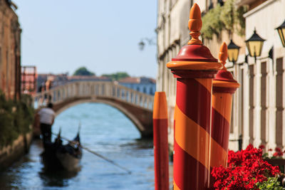 Close-up of red and orange striped poles in grand canal