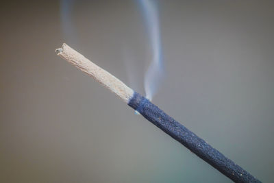 Close-up of cigarette against black background