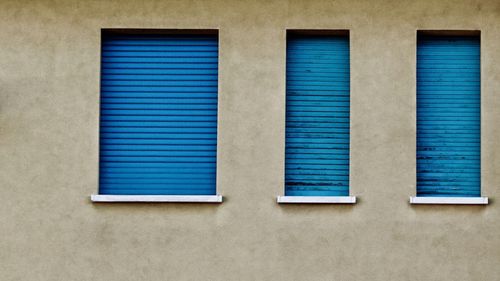 Close-up of blue window on wall of building