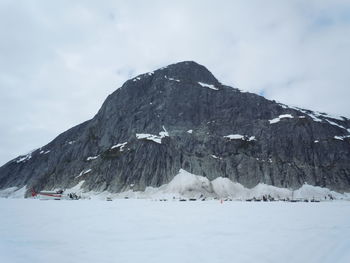 Scenic view of snow covered mountains against sky