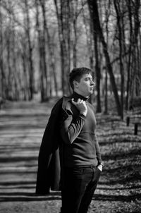 Young woman standing in forest