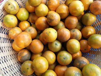 High angle view of oranges in basket at market stall