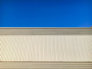 Low angle view of building against clear blue sky