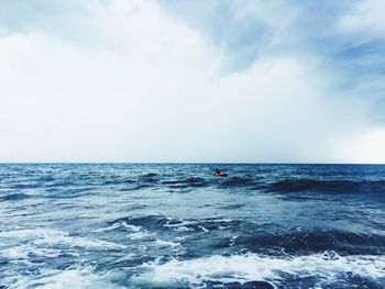 Scenic view of sea against cloudy sky