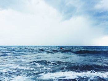 Scenic view of sea against cloudy sky