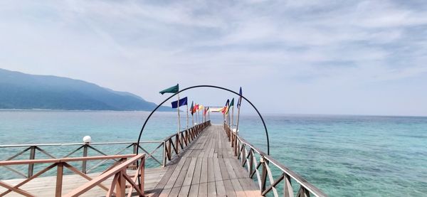 Pier over sea against sky