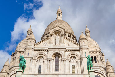 Low angle view of cathedral against cloudy sky