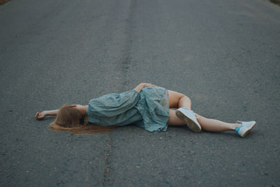 High angle view of man lying on road