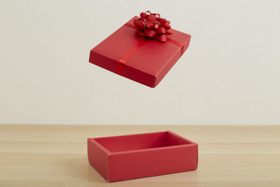 Red umbrella on box against white background