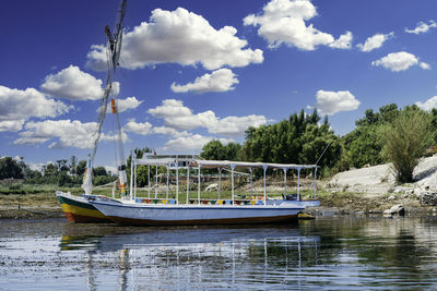 Boat sailing in lake against sky