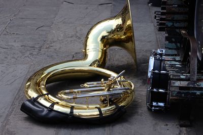 French horn with drum on sidewalk