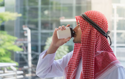 Midsection of man using mobile phone