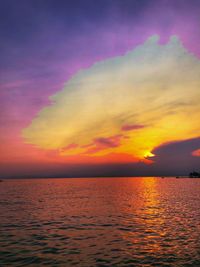 Scenic view of sea against romantic sky at sunset