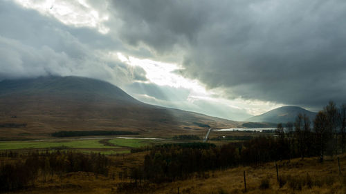 Scenic view of mountains against cloudy sky