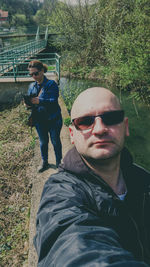 Portrait of man with sunglasses on plants