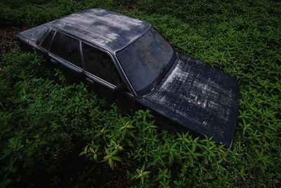 High angle view of old abandoned car on field