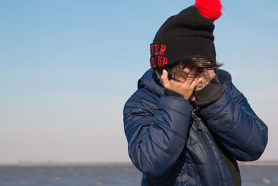 Close up portrait of worried boy outdoors