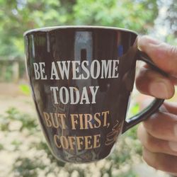 Close-up of hand holding coffee