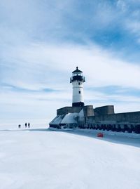 Lighthouse on frozen lake