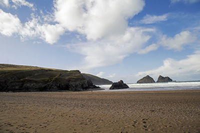 Scenic view of beach and mountains against sky