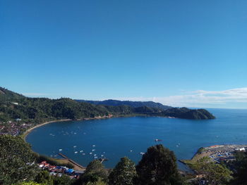 High angle view of bay against clear blue sky