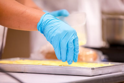 Cropped hands of person preparing food on table