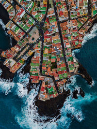 High angle view of buildings by sea