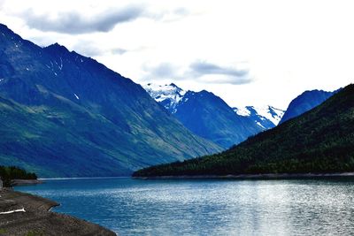 Scenic view of lake and mountains against sky