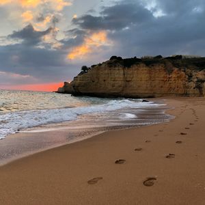 Scenic view of beach against sky during sunset