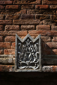 Low angle view of window on wall of building