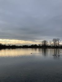 Scenic view of lake against sky during sunset