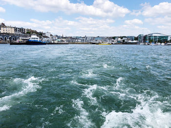 Scenic view of sea and buildings against sky