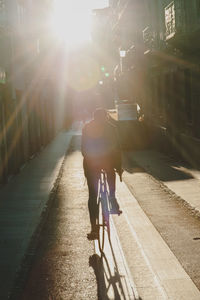 Rear view of woman walking on street in city