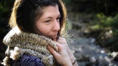 Smiling woman looking away in forest