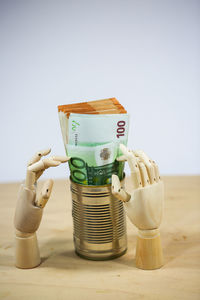 Close-up of coins on table against white background