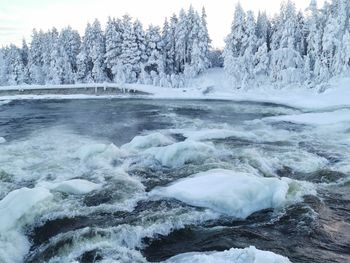 Scenic view of snow covered land and sea