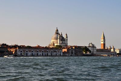 View of buildings in city against clear sky