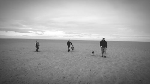 People on beach against sky